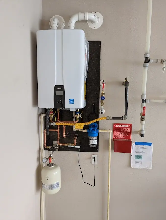 Professional plumber installing copper piping in a Steilacoom home